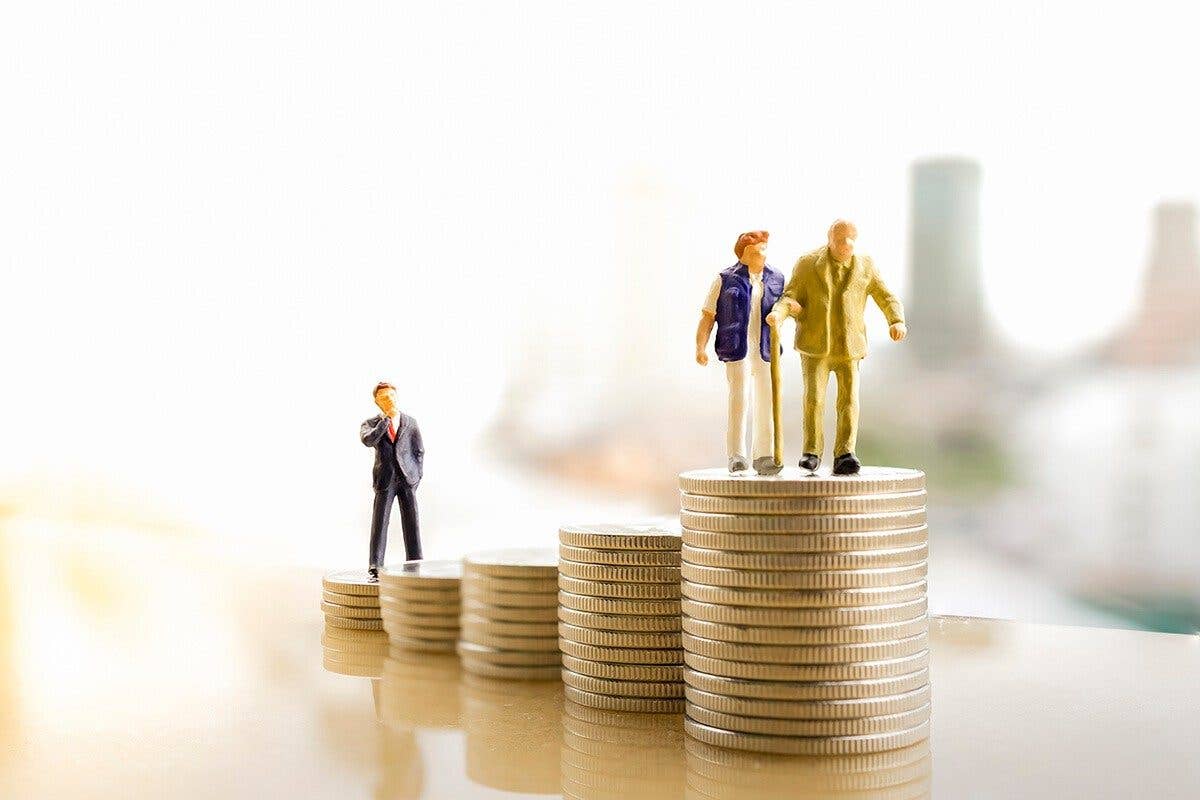 Small plastic people figures on stacked coins