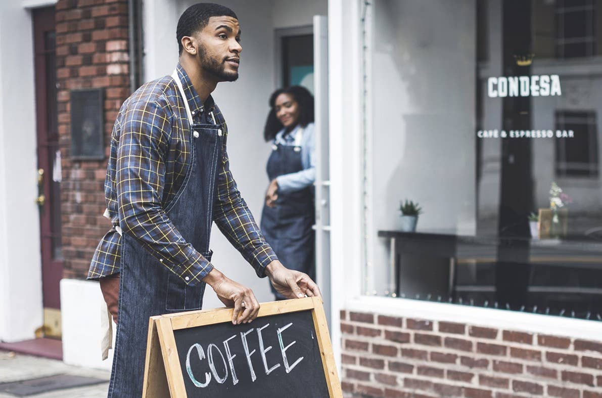 Business owner retrieves sidewalk board