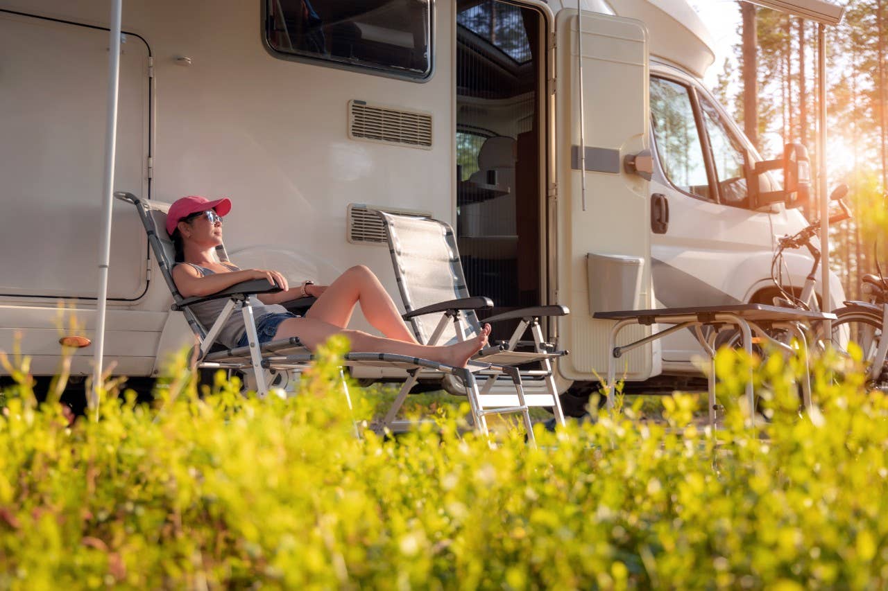 Woman relaxing beside her RV