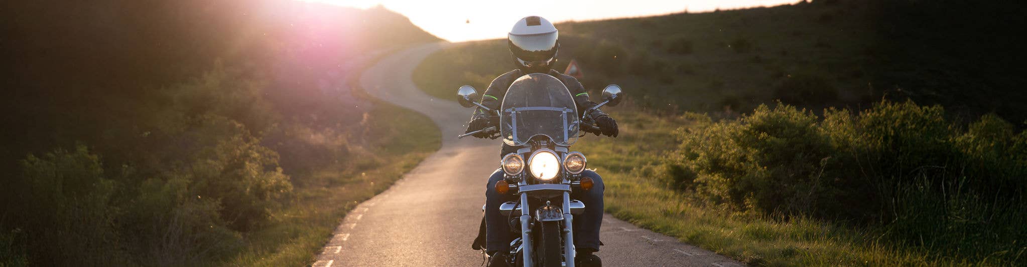 Motorcyclist driving on road